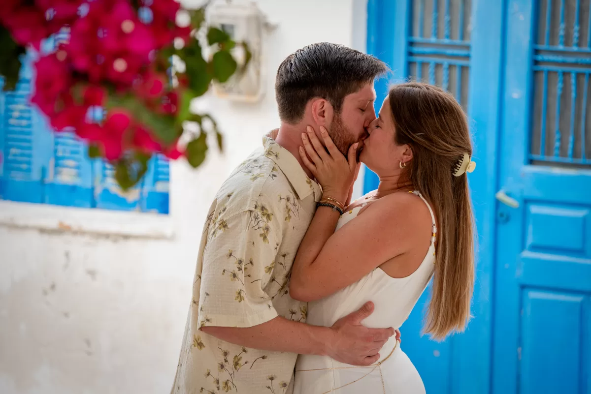 engaged couple kissing in front of beautiful blue door in naxos, by naxos photographer