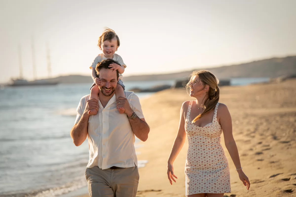 Family with toddler walk and laugh in Maragas beach in Naxos, by naxos photographer
