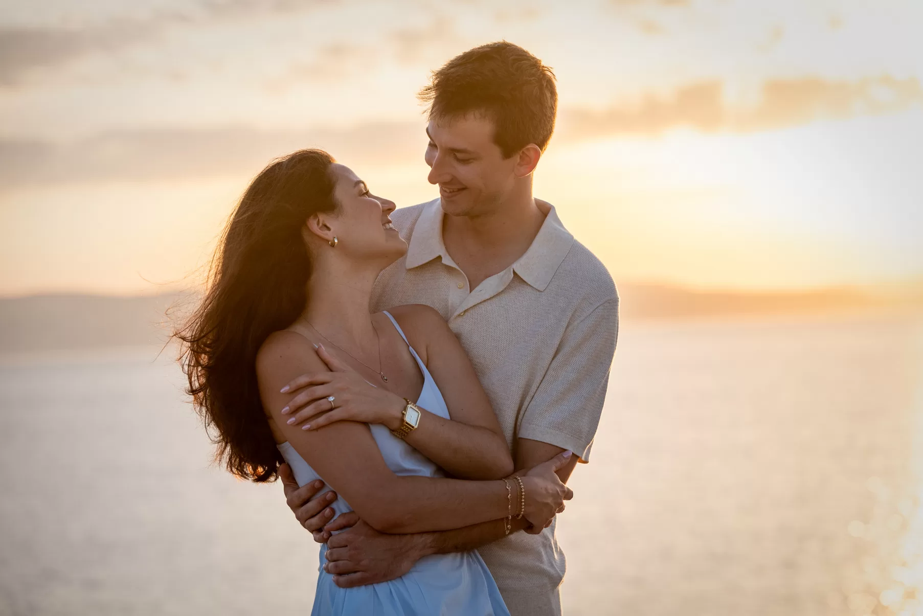 Engaged couple hugging in front of beautiful sunset in Agia Anna Naxos, captured by Naxos Photographer