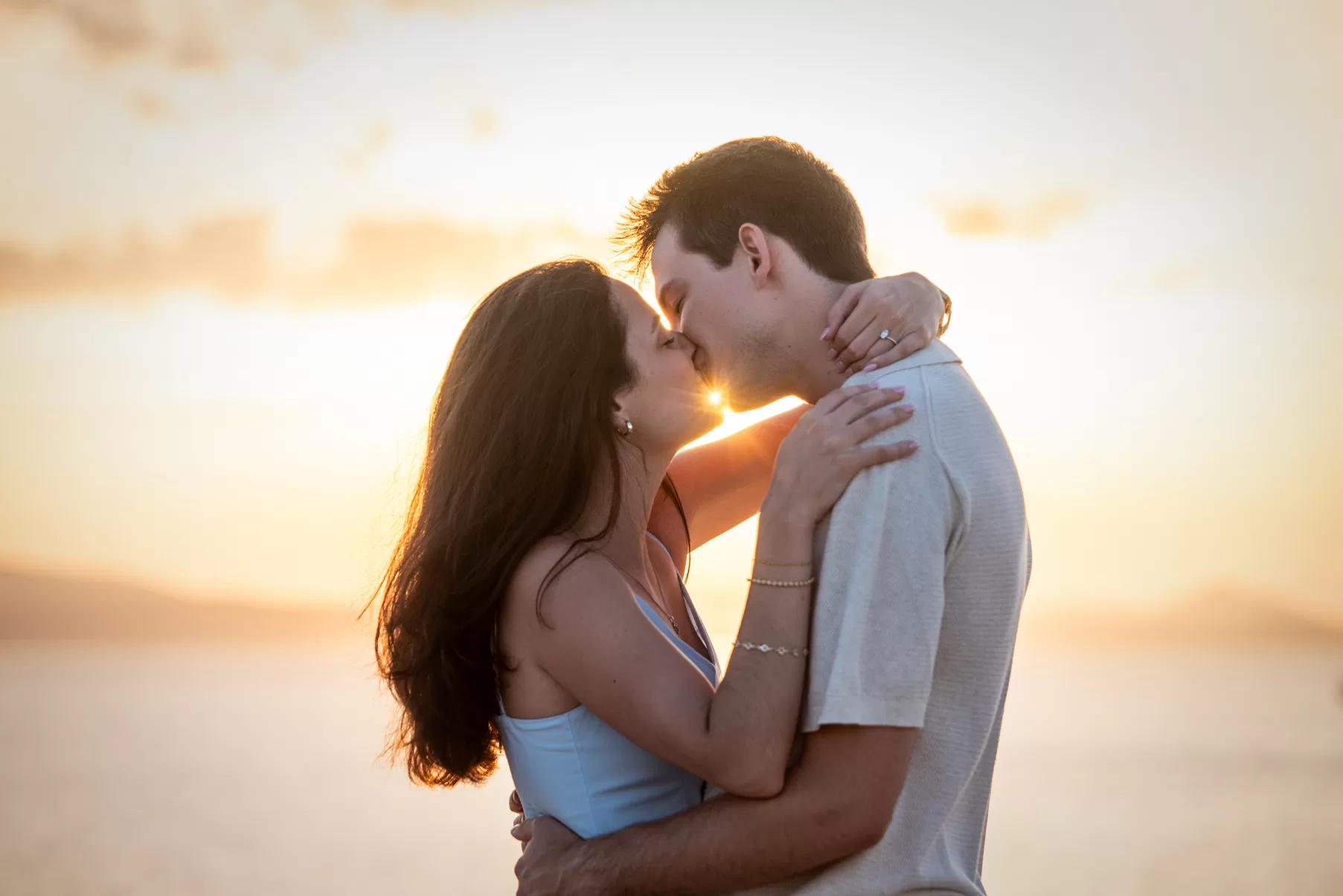 Couple kissing while the sun is in between their faces, captured by Naxos photographer